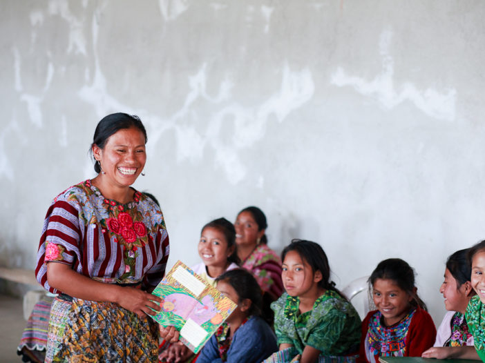 Hermelinda reading to girls in El Llano, Guatemala