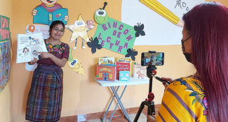 Child Aid literacy trainer records a sample lesson for teacher training workshops